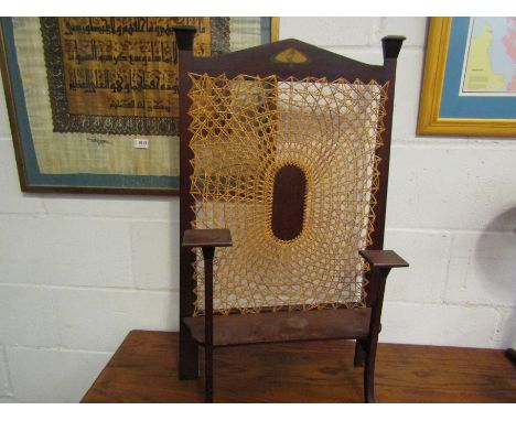 An Art Nouveau mahogany fire screen with cane work panel, 81cm tall