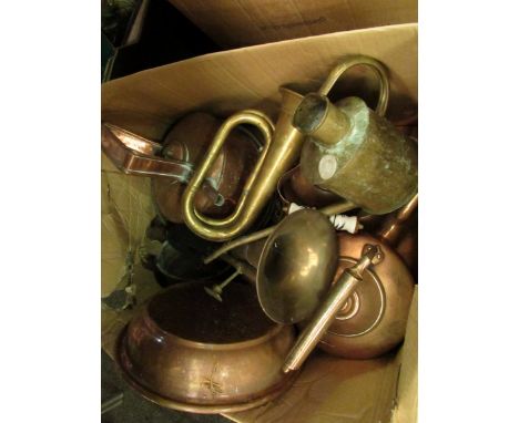 A box of copper and brassware including a Haws watering can, bugle etc.