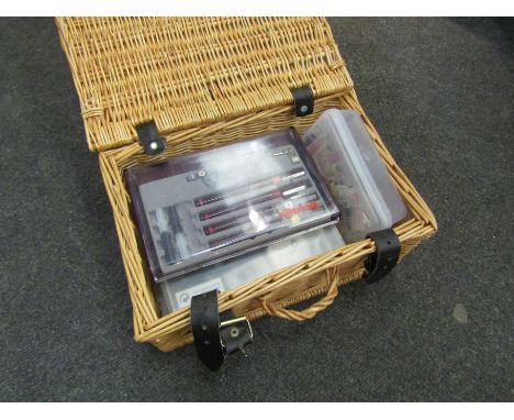 A wicker basket containing Rotring drawing tools including pens and capsules