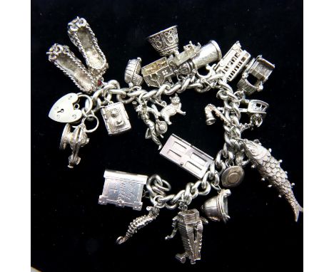 Heavy silver charm bracelet with twenty charms, 123g. P&amp;P Group 1 (£14+VAT for the first lot and £1+VAT for subsequent lo