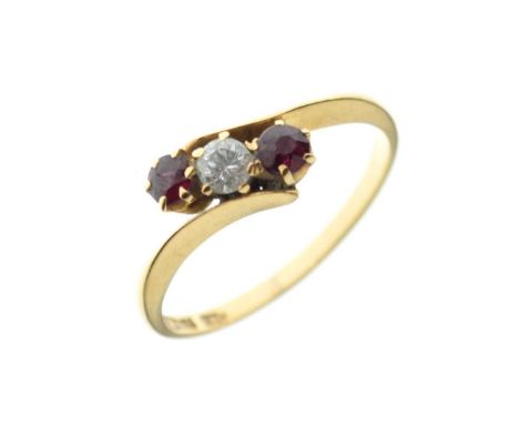 Ruby and diamond three-stone crossover ring, the shank stamped '18c', size P½, 2.6g gross approx