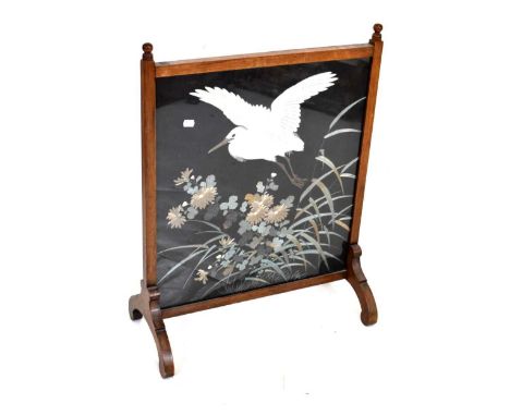 Early 20th Century embroidered firescreen, with Japanese-style silk panel of a crane in flight, within mahogany frame, 57.5cm