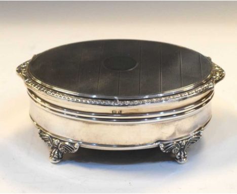 Elizabeth II silver dressing table box of oval form, the hinged lid with engine-turned decoration opening to reveal a fitted 