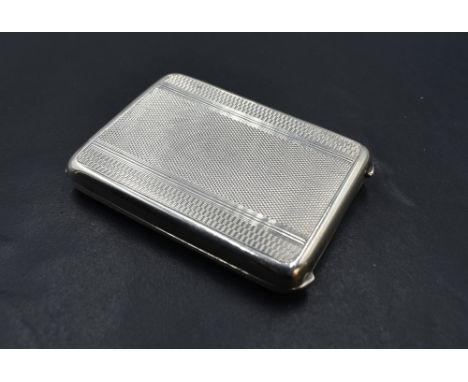 A small 1930's silver card case, of hinged rectangular form with engine-turned decoration, the gilt interior with marks for B