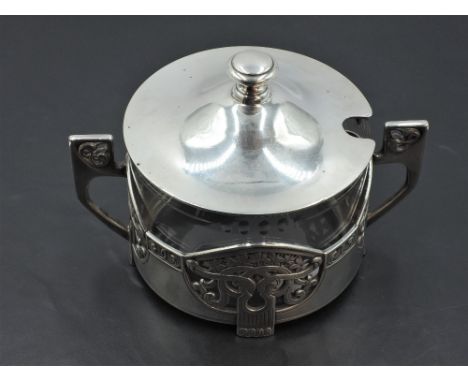 A WMF silver plated sugar bowl having clear glass liner and Art Nouveau style cover having pierced geometric handles and knot