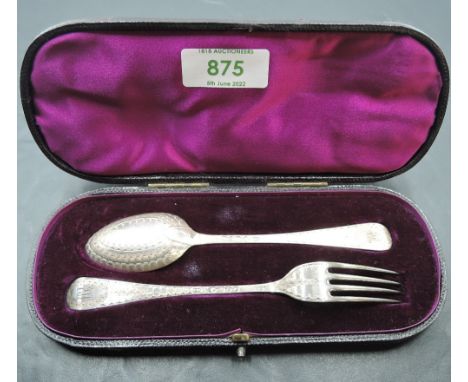 A cased Victorian silver christening set, comprising a Hanovarian pattern spoon and fork, each with bright-cut decoration, ma