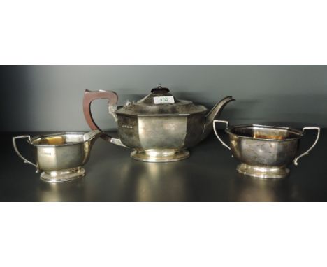 A mid-20th century silver three-piece teaset, comprising teapot, sugar and cream, each of canted rectangular form with reeded