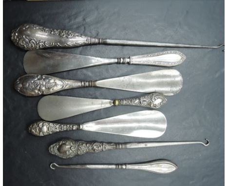 A selection of late 19th/early 20th century silver handled/mounted shoe horns and button hooks, varying designs, dates and ma