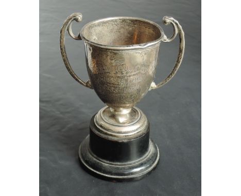 A small Victorian silver two-handled trophy, of traditional design, engraved 'The Wright Cups Messellemias 1933-1934' Marks f