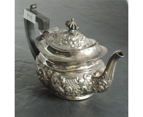 A late Victorian silver teapot, of moulded and rounded rectangular form, the domed cover with ebonised finial the embossed wi