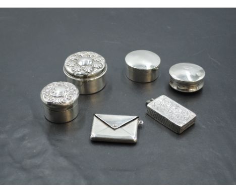 Four HM silver patch boxes, an HM silver stamp holder in form of an envelope and a similar white metal box with side striker,