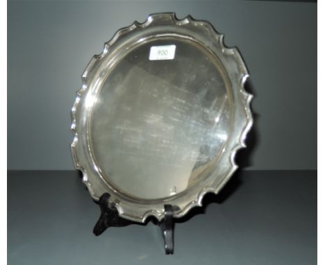 A 1920's silver salver, of circular form with moulded 'Chippendale' edge, engraved inscription to underside along with marks 