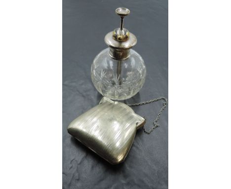 A silver mounted cut glass perfume atomizer, with brass pump and nozzle over the engine turned silver mount and spherical cut