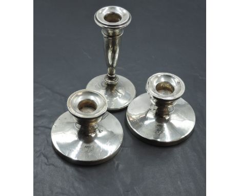 A pair of silver candle sticks of short circular form bearing inscription to front, Birmingham 1919, makers mark worn, and a 