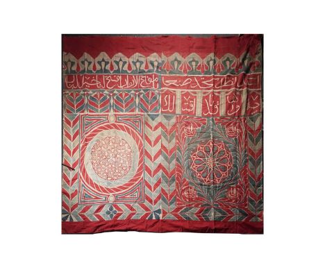 A 19th Century Egyptian Khayamiya, of cotton appliqué, having white calligraphy applied over a red ground, with stylized foli