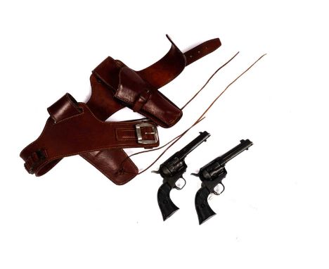 A pair of replica quick-draw pistols in a leather holster, Model single action army 45, pistol 26cm long.