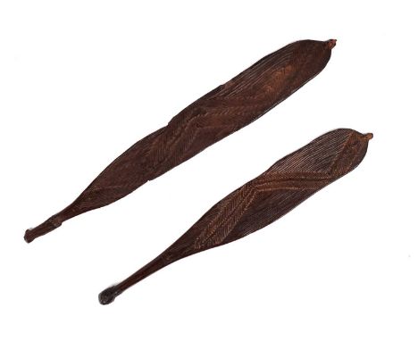 Two Aboriginal hardwood Woomera (spear throwers), with incised geometric decoration, largest 68cm long.