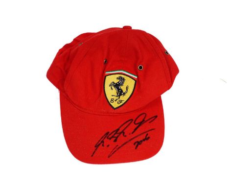 An autographed F1 Formula One Motorsports Ferrari cap, signed in ink by Rubens Barrichello.Provenance: The vendors formerly h