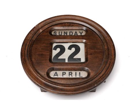 A vintage stained beech perpetual wall calendar, 30cm diameter.