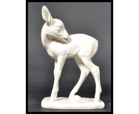 A Goebels ceramic figurine of a deer / faun raised on a white plinth base. Finished in a plain white glaze. Artist signature 