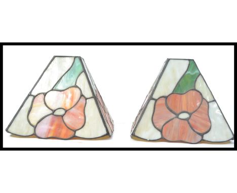 A pair of 20th Century Tiffany style stained lead glass lamp / ceiling&nbsp; shades, each panel decorated with an oversized p