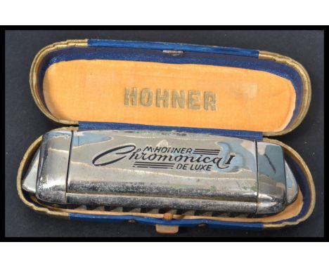 A vintage 20th Century Art Deco cased M. Hohner Chromonica I De - Luxe harmonica. Measures 15 cm wide.