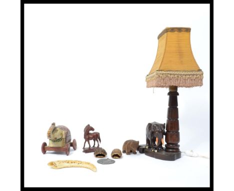 A vintage 20th century carved hardwood lamp modelled as an Elephant, bone carving raised on a socle base, a black forest styl