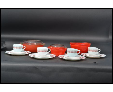 Pyrex - A 1950's vintage retro glass set of cups and saucers in white with a red starburst pattern to include casserole dishe