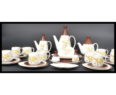A retro 20th century Carltonware dinner service in a two tone brown and cream white colourway having chintz pattern design to