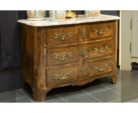 18th Cent. chest of drawers in parquetry with brass inlay, with four drawers with original mountings and with a thick marble 