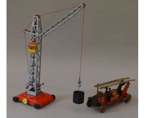 Tinplate tower crane. D.B.G.M (West Germany) G+ together with Mettoy fire engine. F