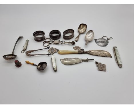 An interesting group of silver, to include: a Georgian caddy spoon; three napkin rings, a Georgian sifter ladle; three silver