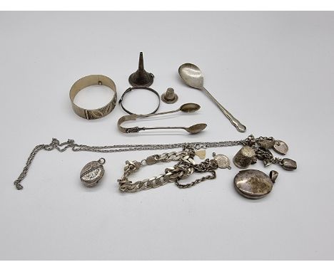 A small quantity of silver and white metal jewellery; to include a curb bracelet; a hinged bangle; two lockets and a sterling