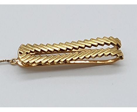 (NB) A Van Cleef &amp; Arpels tie clip,&nbsp;circa 1960s, stamped 750 and French control marks, signed and numbered 87.882, 4