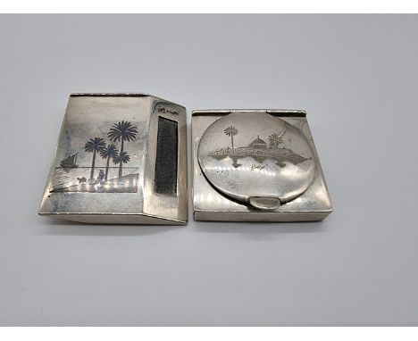 An Egyptian niello vesta case, decorated Nile scenes, 5.8cm; together with another Egyptian white metal compact, decorated Ni