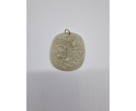 A Chinese carved celadon jade pendant, 54mm high. 