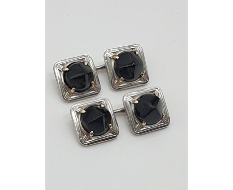 (NB) A pair Art Deco square cufflinks, set onyx with horse bit type links, gross weight 16.7g. 
