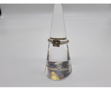 A diamond solitaire ring, stamped 18c Plat, size K. 
