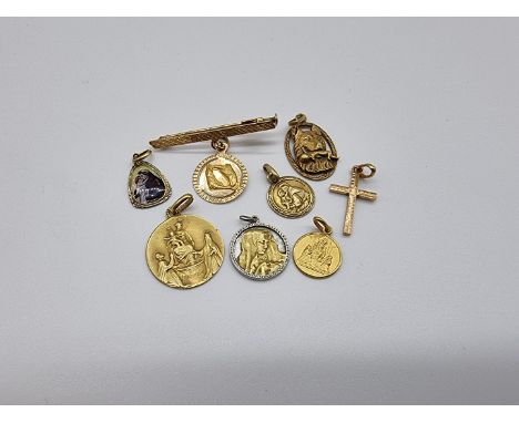 Five yellow metal pendants, stamped 18k/750, one decorated coloured enamel; together with a yellow metal bar brooch, stamped 