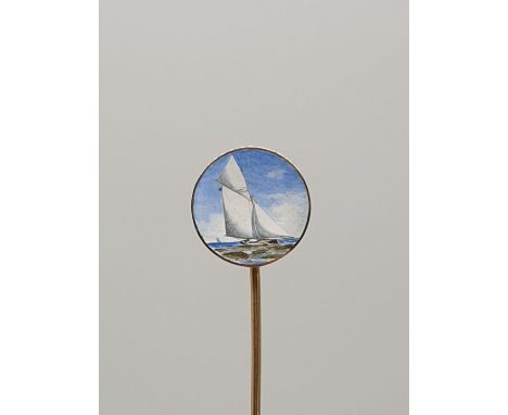 (NB) A late Victorian yellow metal and enamel stick pin, the circular terminal decorated J Class yacht in full sail, 75mm. 