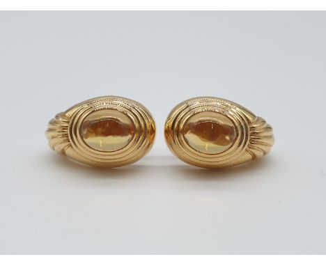 (NB) A pair of 1970s Boucheron abstract half hoop ear clips, set oval cabochon citrine, signed and numbered, with Italian and