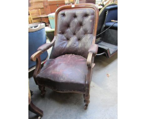 An early 19th Century mahogany and leatherette button-back scroll arm armchair   