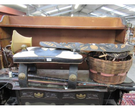 A camel stool, elephant lamp and a collection of ethnic items including axe, spear, masks etc 