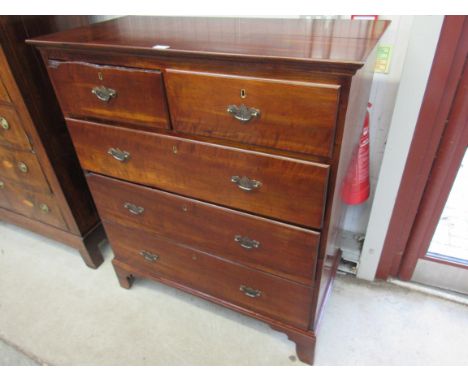 A Georgian polished walnut chest of two over three drawers on bracket feet, new handles, split 