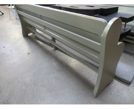 A painted pine pew with removable cushion seat, 235cm long            