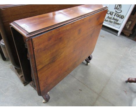 An early Victorian walnut Sutherland table on white ceramic castors 