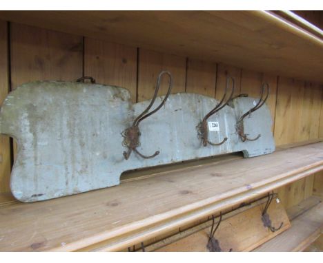 Three wire coat hooks on an Art Nouveau shaped timer panel 