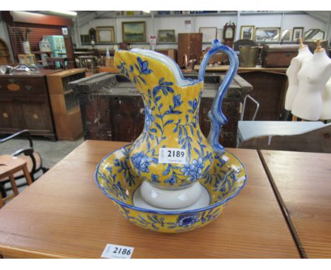 A blue and yellow ceramic wash bowl and jug       
