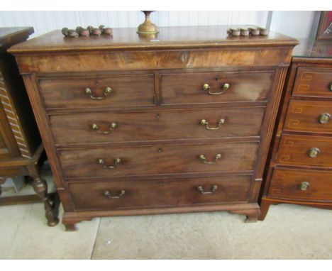 A George III flame mahogany chest of two short over four long drawers on ogee bracket feet, back foot lose