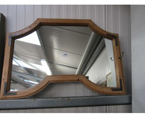 A country pine framed wall mirror with metal bracket decoration           
